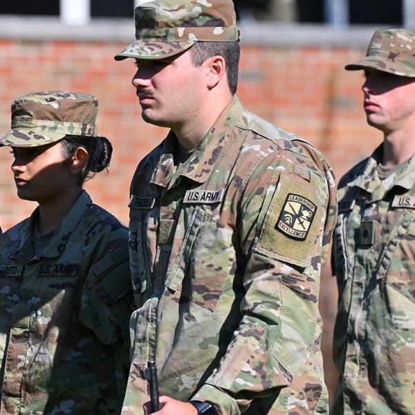 Military officers walk in formation.