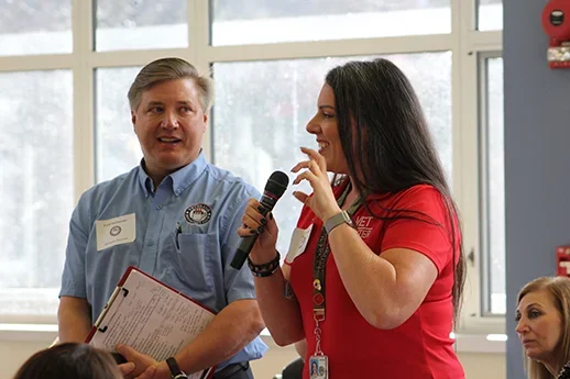 Two individuals speaking at Veterans Breakfast Club event