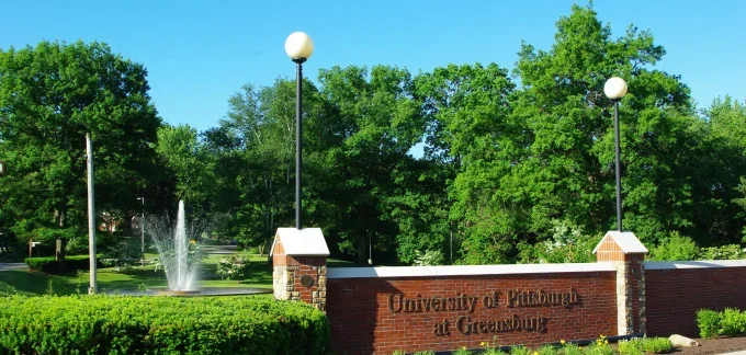 Entrance of campus with fountain and brick lightpost wall