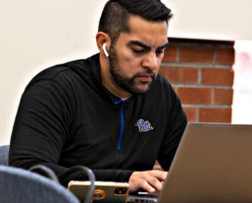 A commuter student works on an assignment.