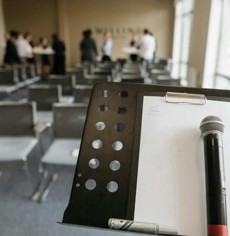 Microphone on podium in front of chairs